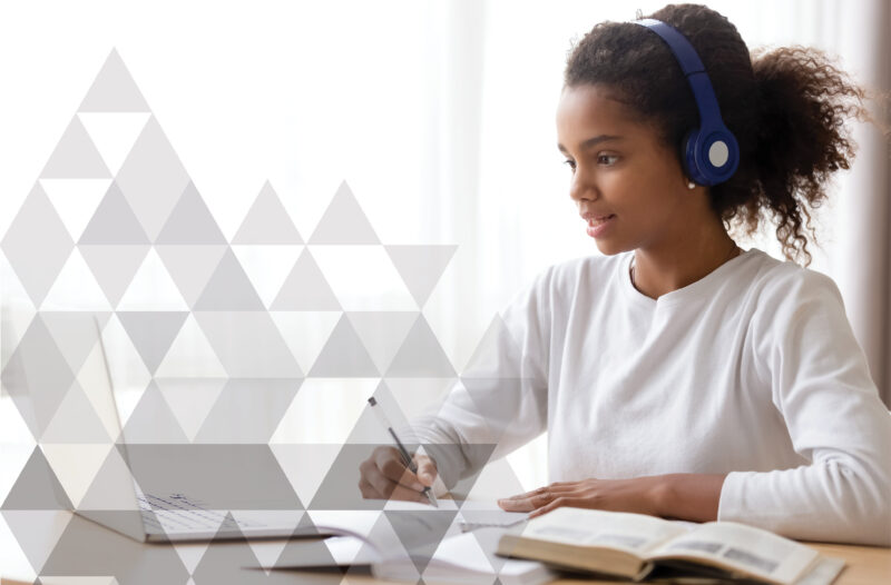 Adaptively Education - Online Tutoring + Learning. Young girl with headphones on the computer learning.