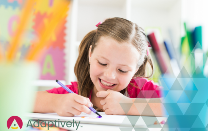 A girl is smiling happily while learning and writing
