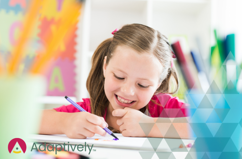 A girl is smiling happily while learning and writing